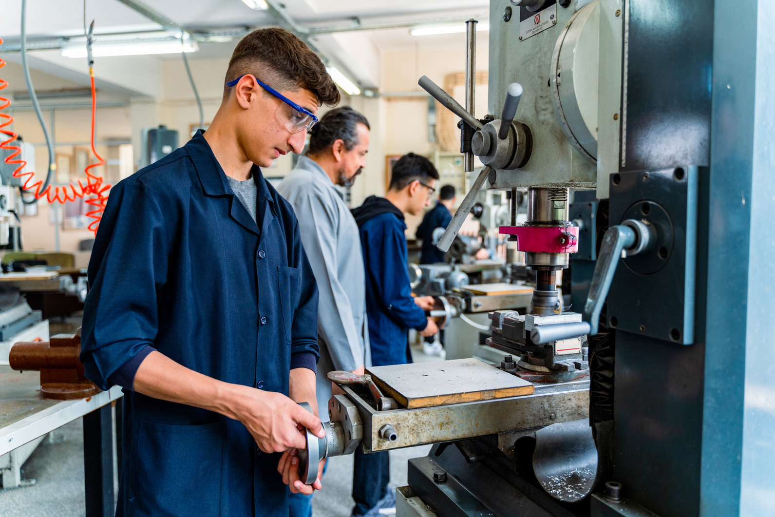 Group of young people in technical vocational training with teacher