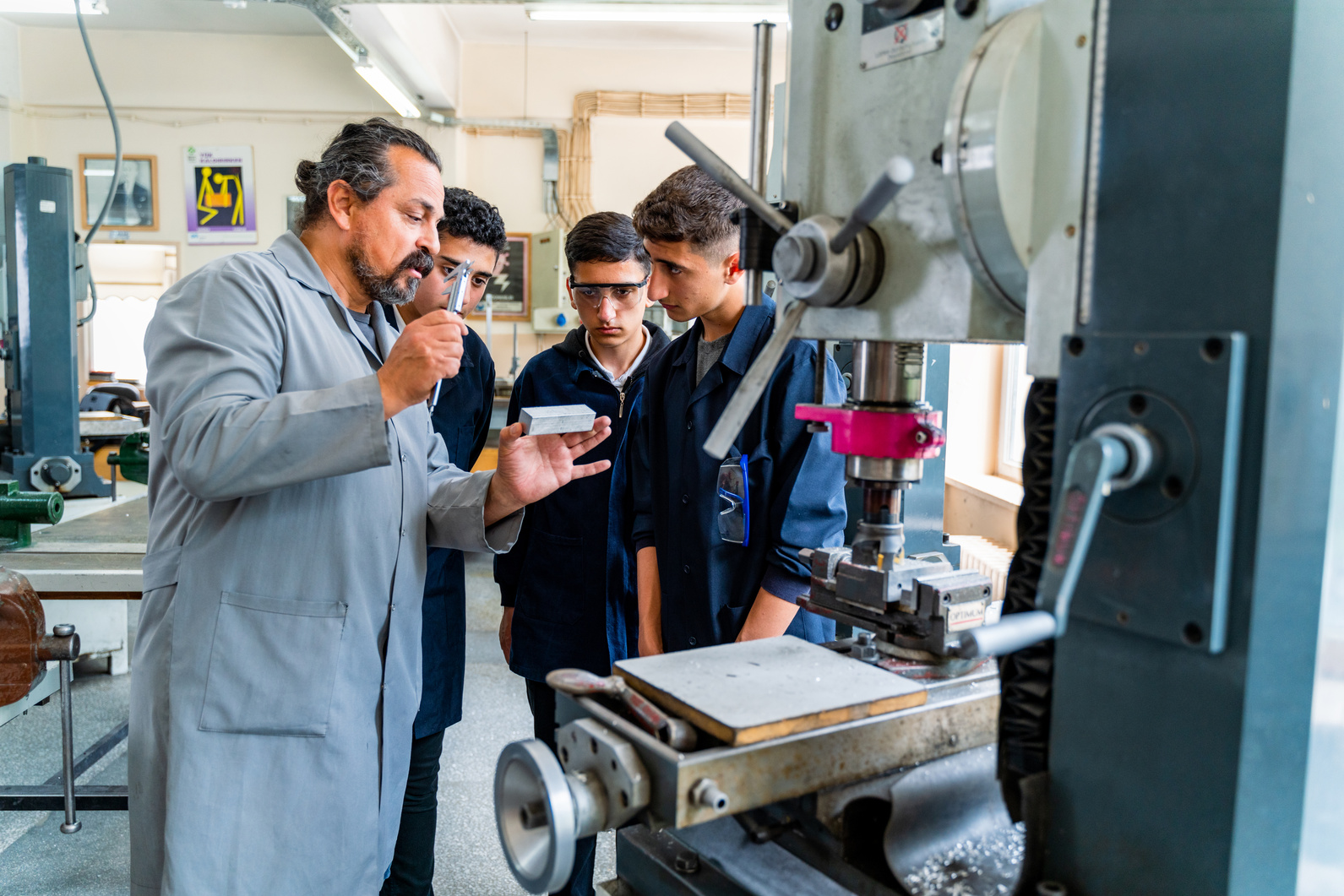 Group of young people in technical vocational training with teacher